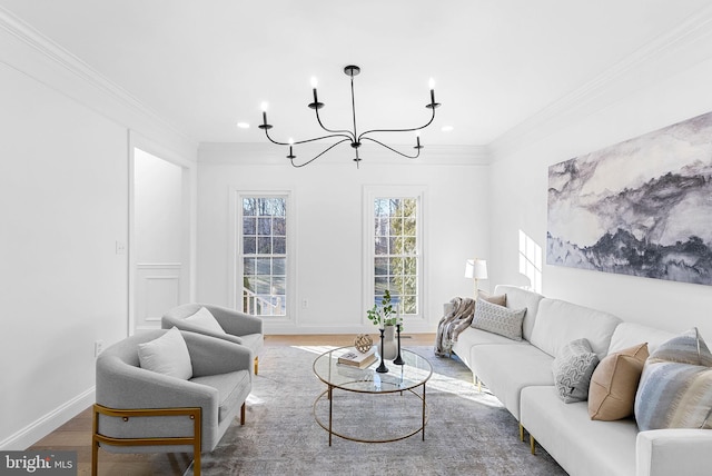 living room featuring hardwood / wood-style floors, crown molding, and a notable chandelier