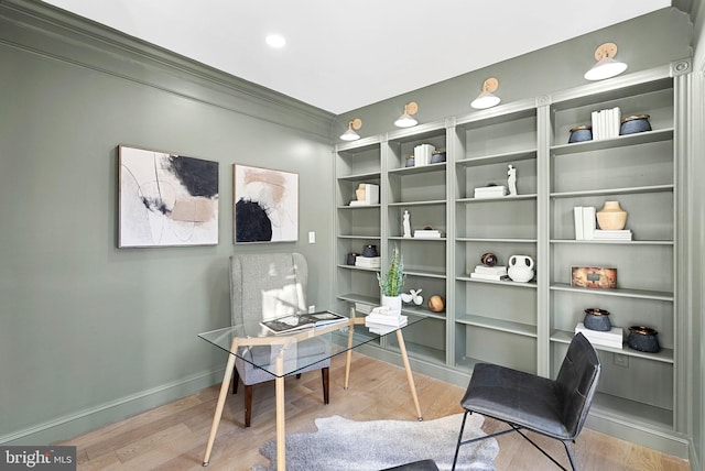 office with ornamental molding and light wood-type flooring