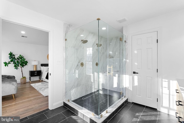 bathroom featuring hardwood / wood-style flooring and a shower with shower door