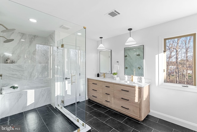 bathroom featuring a shower with door, vanity, and tile patterned flooring