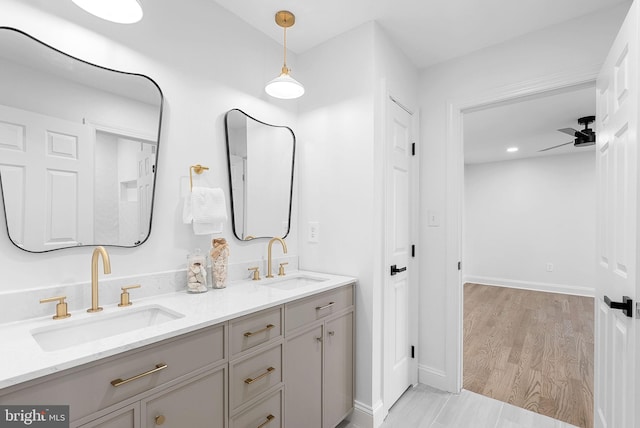 bathroom featuring vanity, hardwood / wood-style floors, and ceiling fan