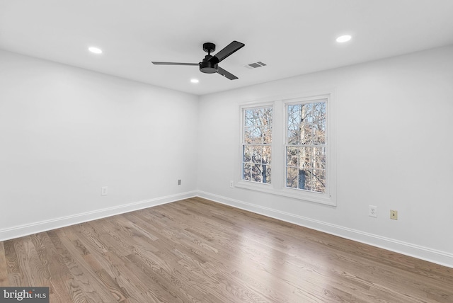 unfurnished room with hardwood / wood-style flooring and ceiling fan