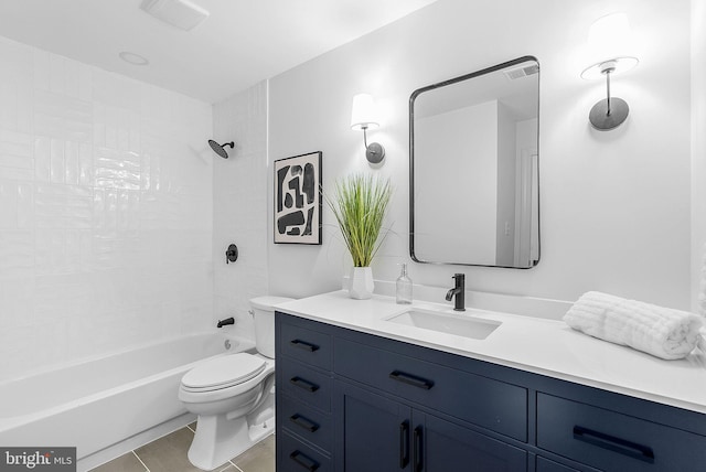 full bathroom with vanity, tile patterned floors, toilet, and tiled shower / bath