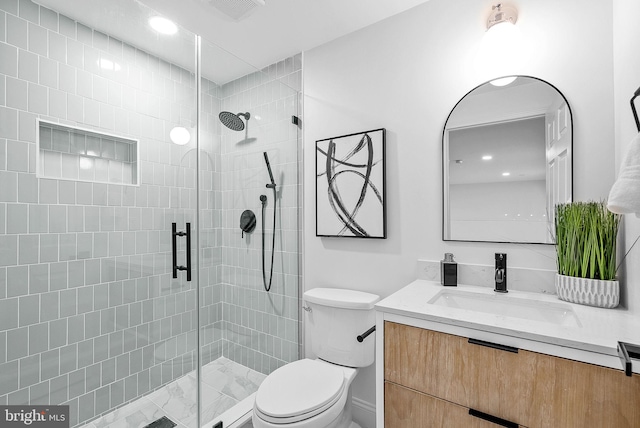 bathroom with walk in shower, vanity, and toilet