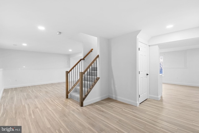 basement with light hardwood / wood-style flooring