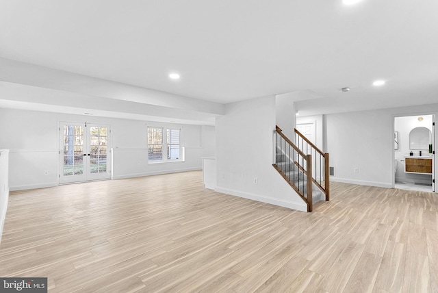 living room featuring french doors and light hardwood / wood-style flooring