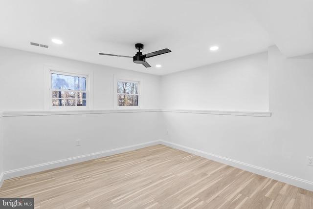 spare room with ceiling fan and light wood-type flooring