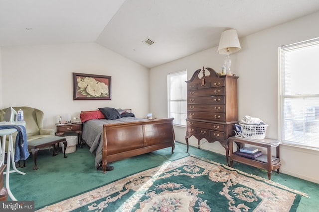 carpeted bedroom with vaulted ceiling and multiple windows