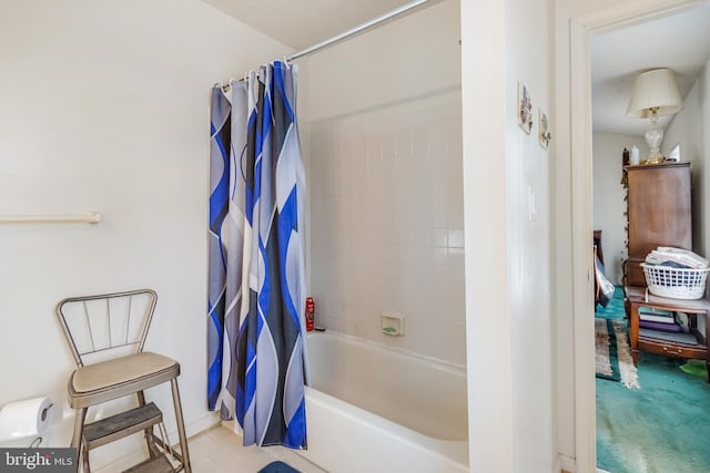 bathroom with shower / tub combo and tile patterned flooring