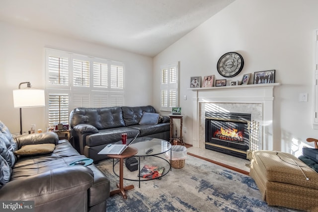 living room with a fireplace and lofted ceiling