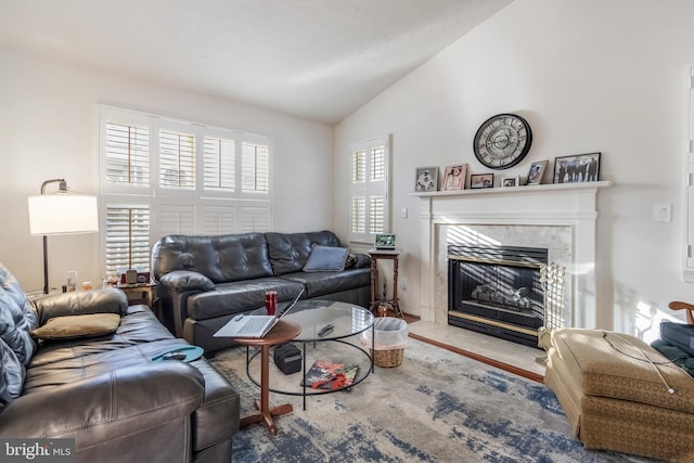 living room with vaulted ceiling and a fireplace