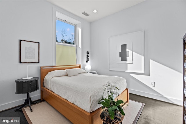 bedroom with dark wood-type flooring