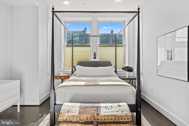 bedroom with dark wood-type flooring