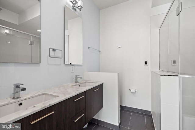 bathroom featuring vanity, tile patterned floors, and a shower with door