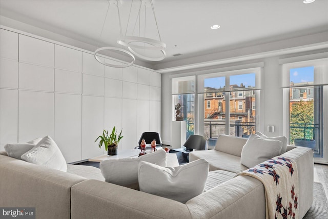 living room with wood-type flooring and a healthy amount of sunlight