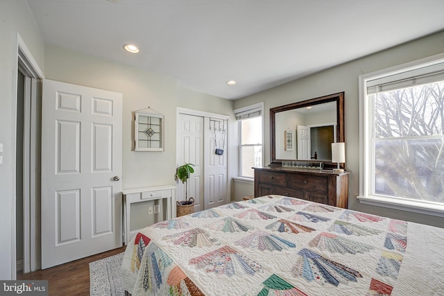 bedroom with dark wood-type flooring and a closet