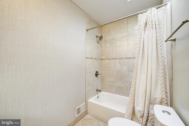 bathroom with toilet, shower / bath combo, and tile patterned flooring