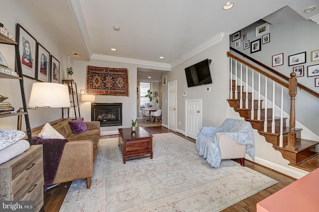 living room featuring crown molding and hardwood / wood-style floors