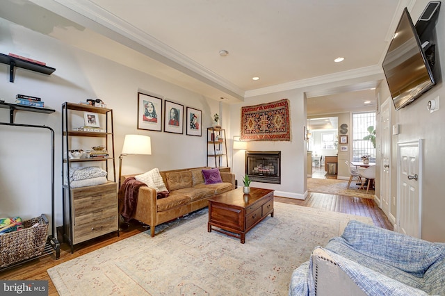 living room featuring light hardwood / wood-style flooring and crown molding