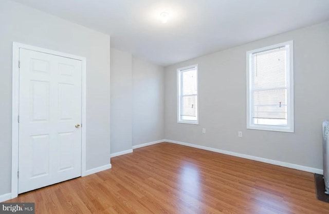 unfurnished room with light hardwood / wood-style floors