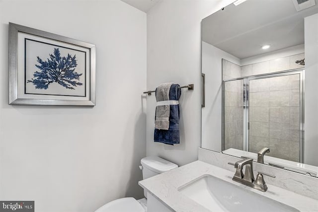 bathroom with vanity, toilet, and an enclosed shower