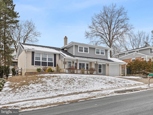 view of front property with covered porch and a garage