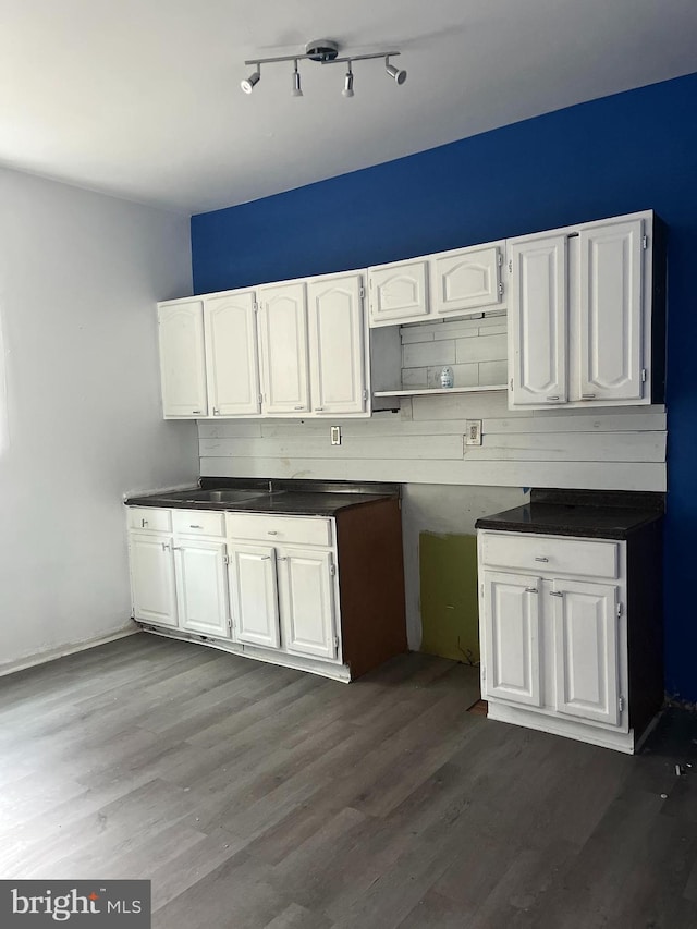 kitchen featuring white cabinets and dark hardwood / wood-style floors