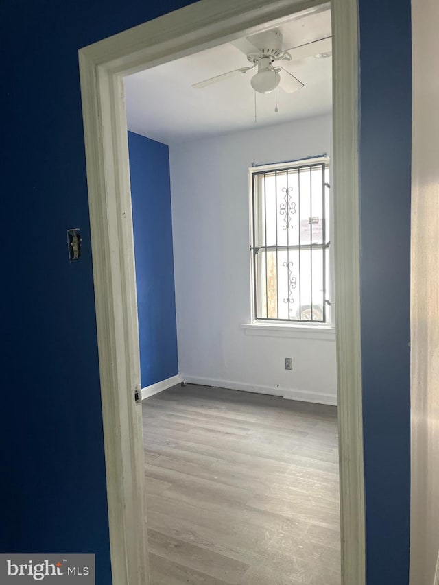 empty room featuring light hardwood / wood-style flooring and ceiling fan