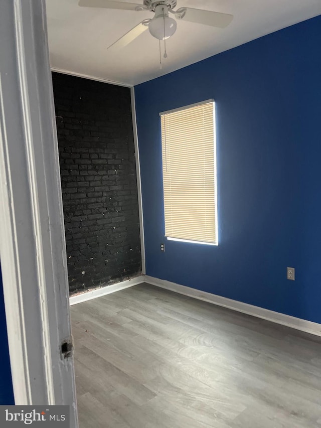 empty room with light hardwood / wood-style floors and ceiling fan