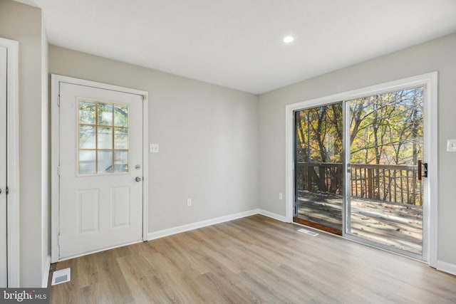 foyer featuring light hardwood / wood-style flooring and a healthy amount of sunlight