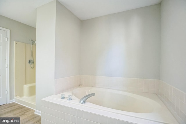 bathroom with hardwood / wood-style floors and plus walk in shower