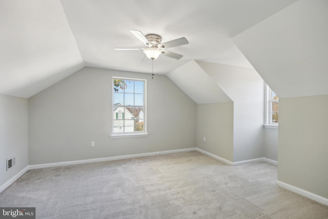 bonus room featuring light colored carpet, vaulted ceiling, and ceiling fan