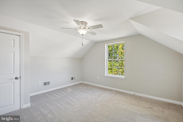 bonus room with ceiling fan, light carpet, and vaulted ceiling