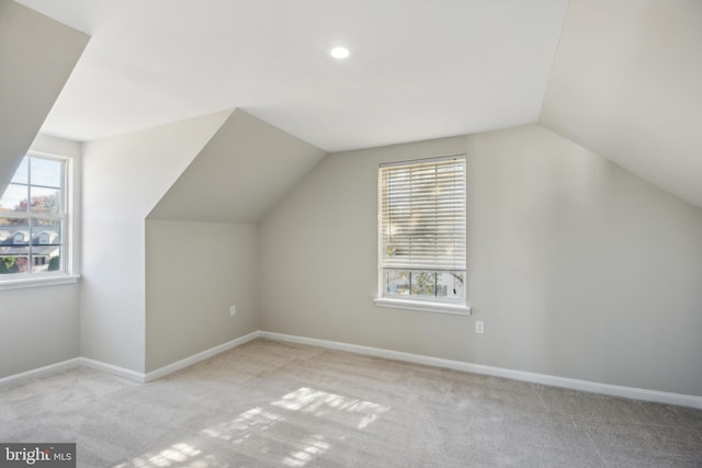 bonus room featuring light colored carpet and lofted ceiling