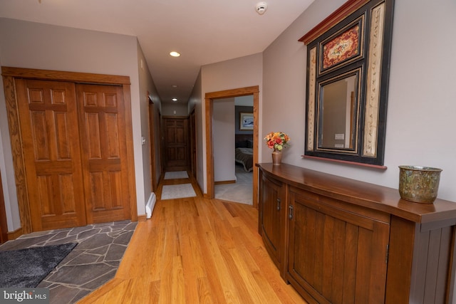 corridor with light hardwood / wood-style floors