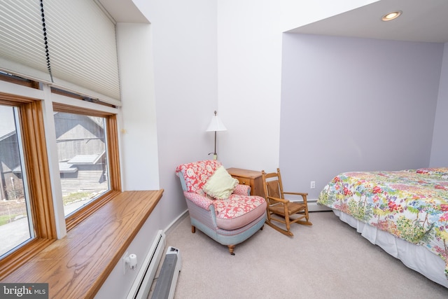 bedroom with light colored carpet and baseboard heating