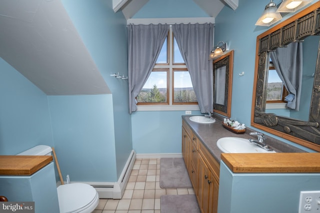 bathroom featuring lofted ceiling, toilet, tile patterned flooring, and vanity