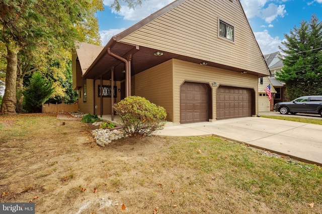 view of property exterior with a garage and a lawn