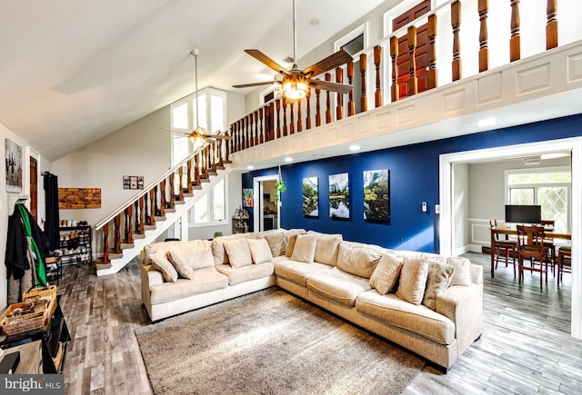 living room with ceiling fan, high vaulted ceiling, and hardwood / wood-style floors