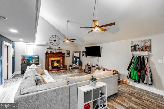 living room featuring vaulted ceiling, ceiling fan, and wood-type flooring