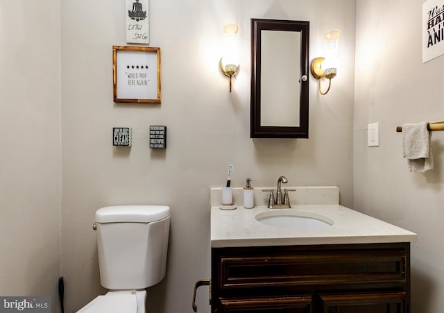 bathroom featuring toilet and vanity