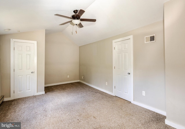 interior space with ceiling fan, carpet floors, and lofted ceiling