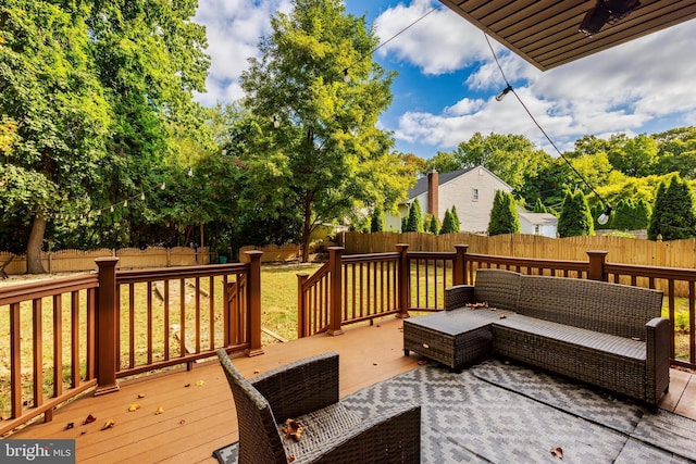 wooden terrace featuring an outdoor living space