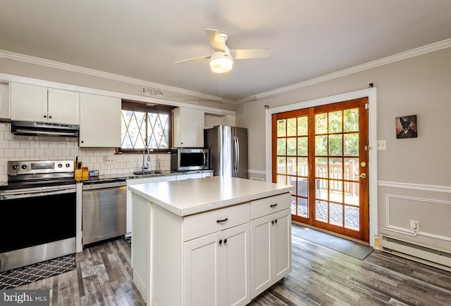 kitchen featuring sink, white cabinets, a wealth of natural light, a kitchen island, and stainless steel appliances