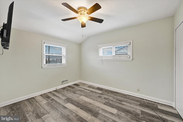 empty room featuring ceiling fan, wood-type flooring, and vaulted ceiling