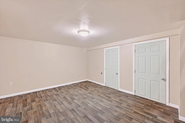 unfurnished bedroom with hardwood / wood-style flooring and a closet