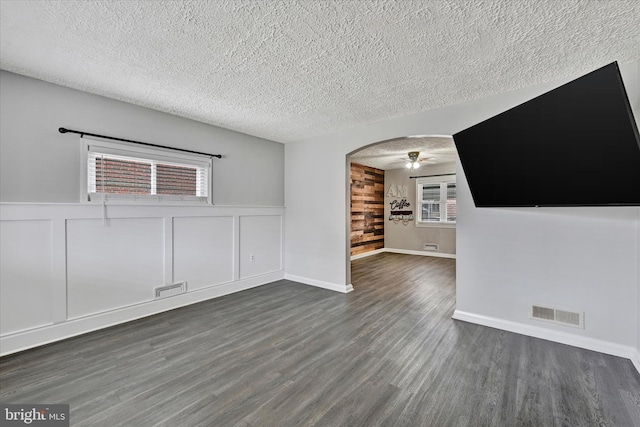 interior space featuring ceiling fan, dark hardwood / wood-style flooring, and a textured ceiling