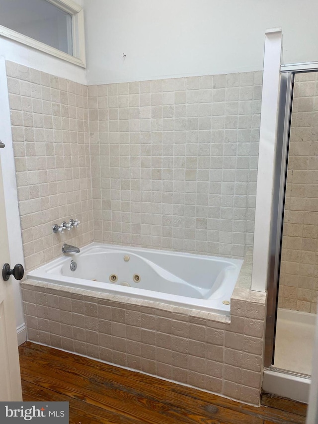 bathroom featuring wood-type flooring and independent shower and bath