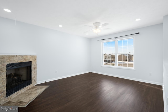 unfurnished living room with ceiling fan and dark hardwood / wood-style flooring