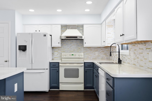 kitchen featuring white cabinetry, white appliances, wall chimney exhaust hood, and sink